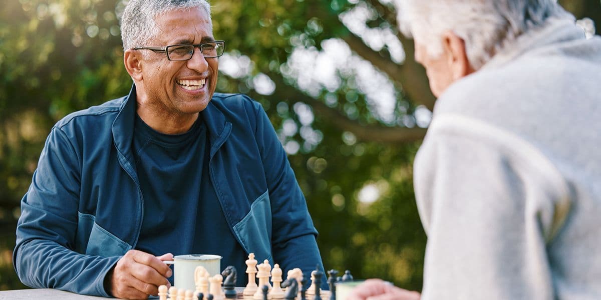 senior men playing a game of chess