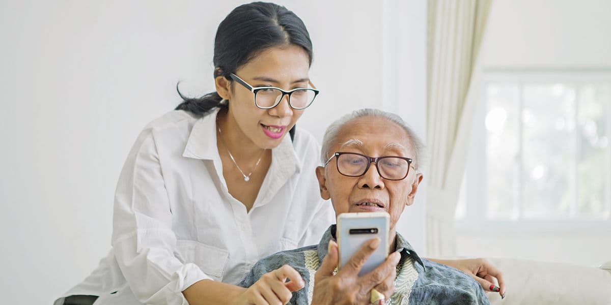 Asian woman helping older father