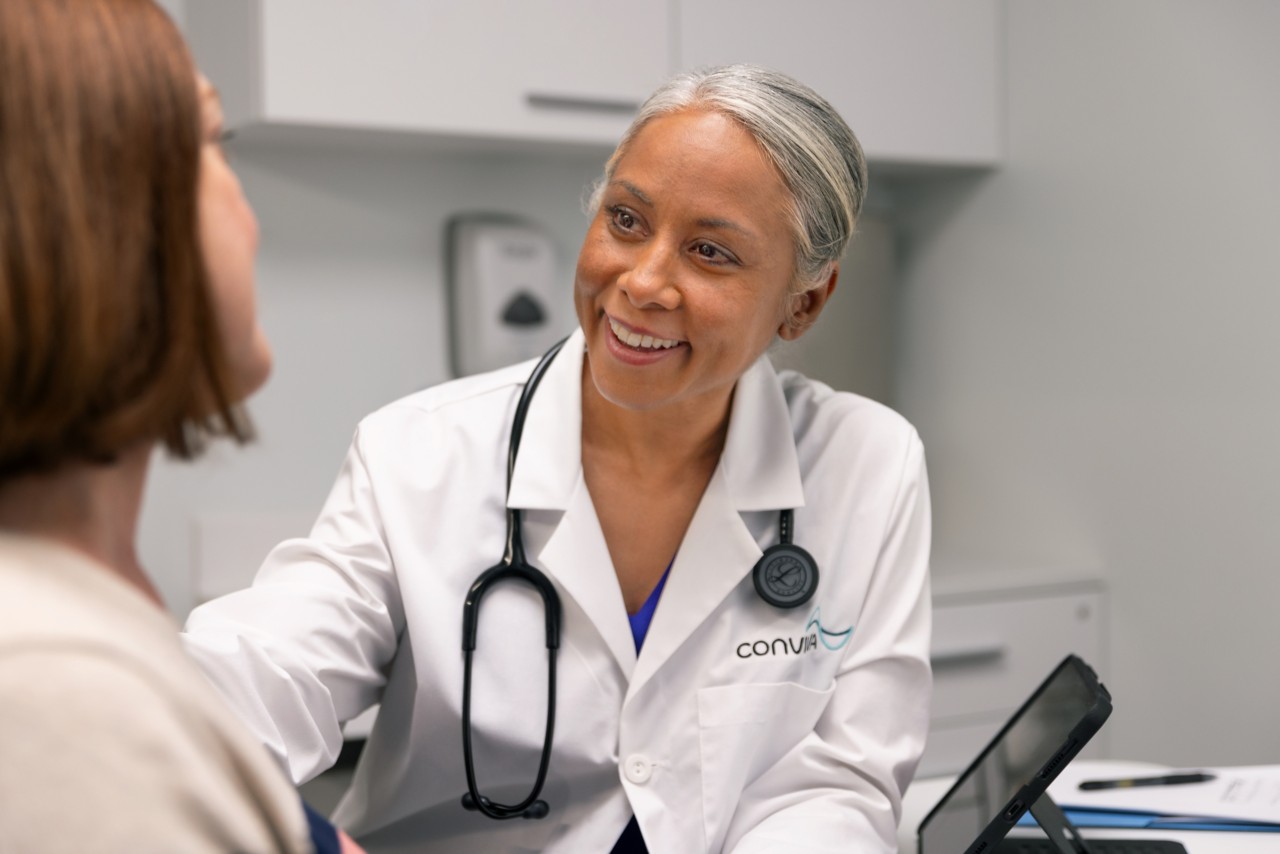 Black female doctor with patient in doctors office